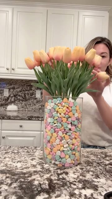 Stephanie arranging peach tulips in a candy-heart vase